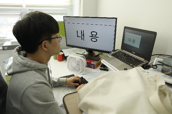 Hoyong working hard at his desk main image